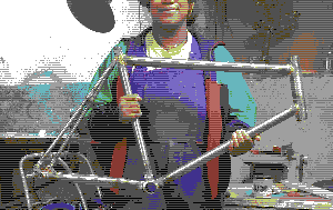 Picture of me cropped to the smile holding the frame after finish the bigger parts of solder brazing it