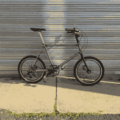 Little 20 bicycle in front of a metal roll up garage door