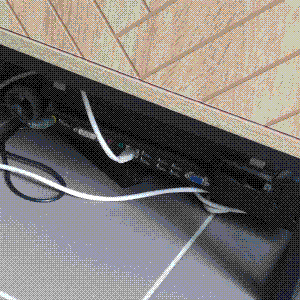 back of the dock of x220 laptop under a cabinet with a white ethernet RJ45 cable and power cable plugged in